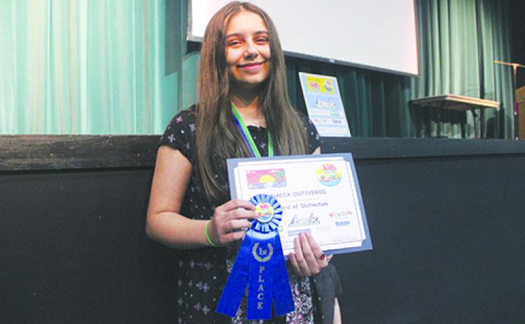 Putnam County Kids Tag Art first-place winner Nadia Ontiveros celebrates her accomplishment Tuesday at the Florida School of the Arts in Palatka.