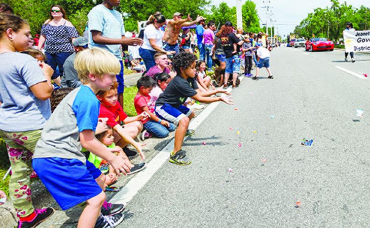 Children catch candy during last year's Catfish Festival.