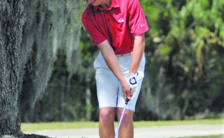 Miles Albrighton of Ocala chips his third shot to No. 4 green from the sandy cart path during Friday’s first round. (GREG WALKER / Special To The Daily News)