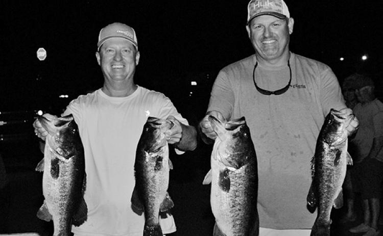 Troy Ward (left) and Tim Mann hold up their winning fish. (GREG WALKER / Special to the Daily News)