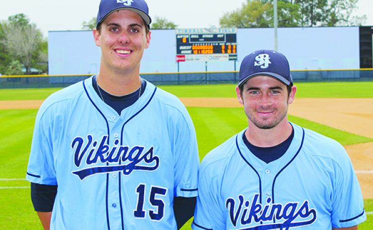 St. Johns River State College baseball pitchers, from left, Brad Torres and Trae Ratliff pose in front of the scoreboard at Tindall Field after combining on a perfect game against Lake-Sumter. (ANDY HALL / Palatka Daily News)