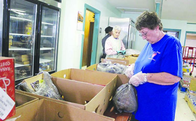 Volunteers package food at Heart of Putnam.