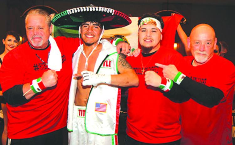 Benny Aguilar celebrates winning his lightweight bout on Feb. 8 at the Hard Rock Hotel in Daytona Beach with, from left, former Palatka PAL leader and volunteer Barry Stewart, head of boxing Faustino Garcia and current Palatka PAL leader John Brady. (FAUSTINO GARCIA / Contributed)