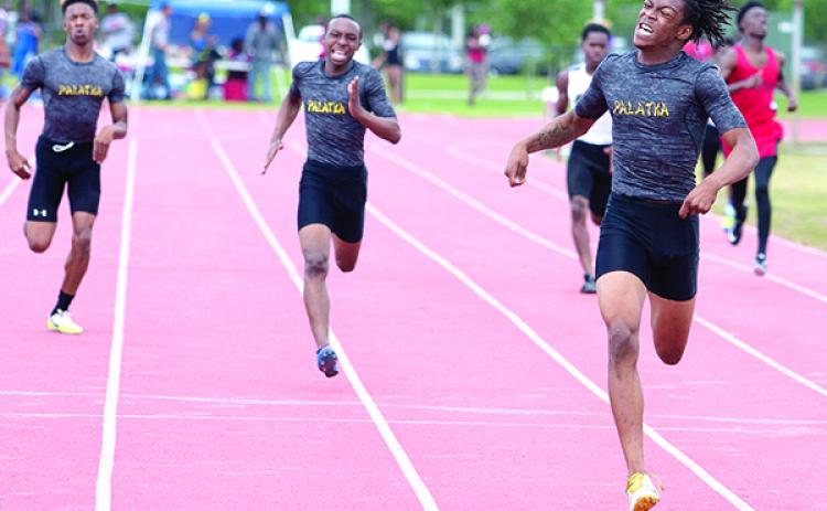 Robert Passmore easily wins the District 5-2A championship in the 400-meter dash on April 14, 2016, as teammates Lutrell Smith (middle) finishes second and Kendrick Aaron (left) takes third at Fred Cone Park, Gainesville. (Daily News file photo)