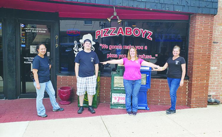 PizzaBoyz employees Michelle Cather, Michael Carson and Holly Sturdivant stand outside with owner Jeannie Ely.