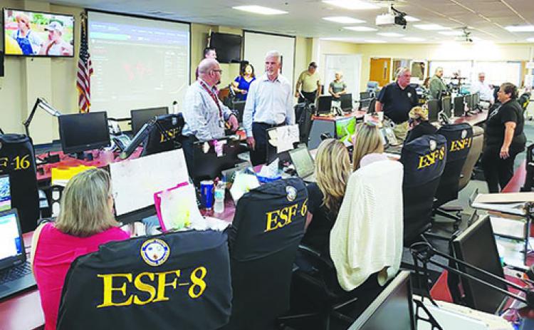 State Sen. Keith Perry, right, talks with interim Putnam County Emergency Management Coordinator Ryan Simpson in the Emergency Operations Center in Palatka on Wednesday.