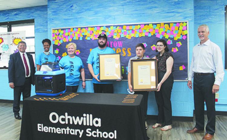 Superintendent Rick Surrency, Ochwilla Elementary School Assistant Principal Sharice Williams, Principal Beth Leary, Robotics Coach Brian Parrish, Brian Bunch, Grace Bunch and state Sen. Keith Perry, R-Gainesville, stand with the proclamations given to Brian Bunch and Parrish on Wednesday.