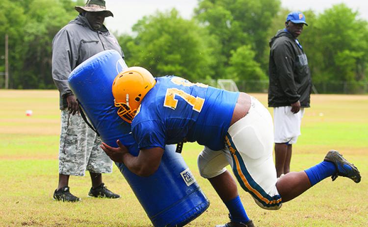 Darrell Polite (left) watches one of his linemen work the tackling dummy during a 2016 Palatka High football practice. Polite was an assistant coach with the program from 1996-2018. (Daily News file photo)
