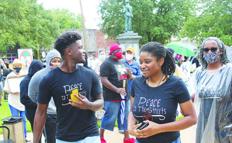 PEACE in the STREETS protest organizers Tevel Adams and Dar’Nesha Leonard lead demonstrators on a victory march around the Putnam County Courthouse on Thursday afternoon.