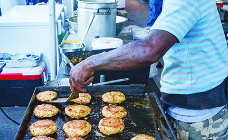 Victor Jones tries to keep up with the demand for what he boasted were the biggest and best crab cakes in all of Florida at the Blue Crab Festival last year.