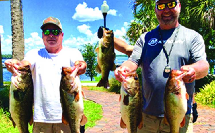 Alan Hopper and Chad Willoughby hold up their winning fish Saturday. (GREG WALKER / Special To The Daily News)