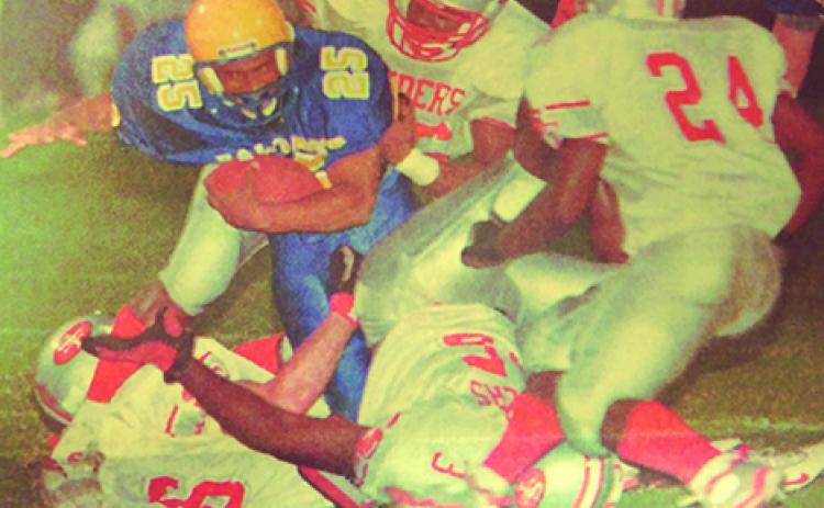 Palatka’s Andre Hill crashes through for yardage in the team’s win over Alachua Santa Fe in 1999. (Daily News file photo0
