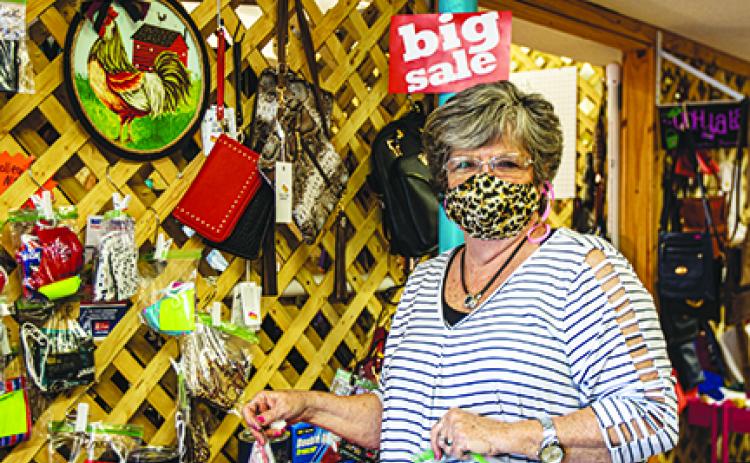 Lynda Williams, owner of Sassy Snaps and Blyng in Rivertown Suites Marketplace in Palatka, shows off the many masks she’s made during the coronavirus pandemic and said making masks kept her business going.