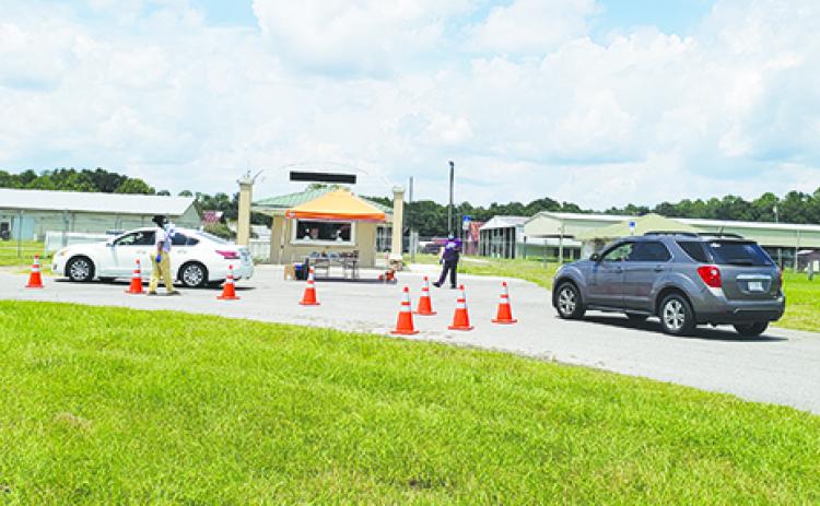 Health officials check in residents Sunday afternoon for free drive-thru COVID-19 testing at the Putnam County Fairgrounds. Drive-thru testing is scheduled again 8 a.m. – 1 p.m. today at the fairgrounds.
