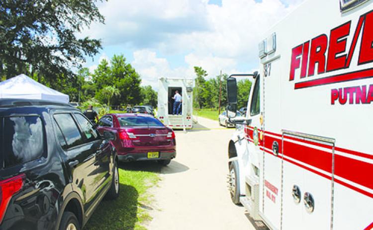 The Putnam County Sheriff’s Office stations its mobile command unit and tents for deputies in Melrose, where to teenagers were found dead Wednesday morning.