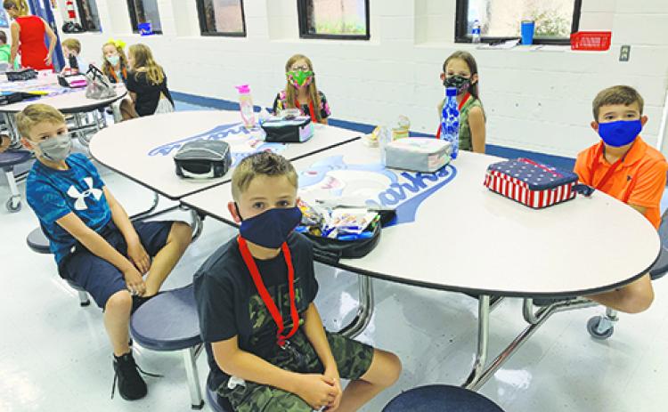 Children from Kelley Smith Elementary School smile at lunch on their first day back at school. Census reporting ends next month and data will help rural county schools receive funding to improve programs.