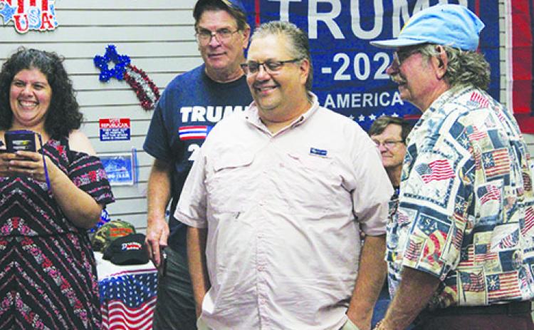 Paul Adamczyk, center, celebrates with supporters at the Republican Party headquarters in Palatka on Tuesday.