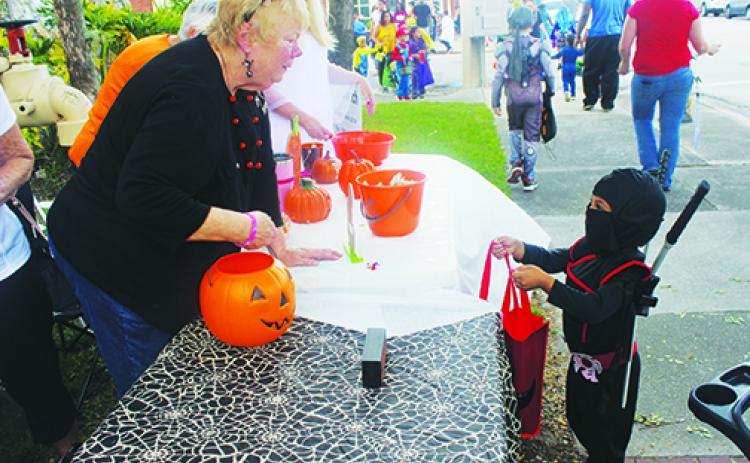 Trick-or-treaters line up for goodies during last year’s Boo! on the Avenue in Palatka. City commissioners are looking for creative ways to host holiday events this year.