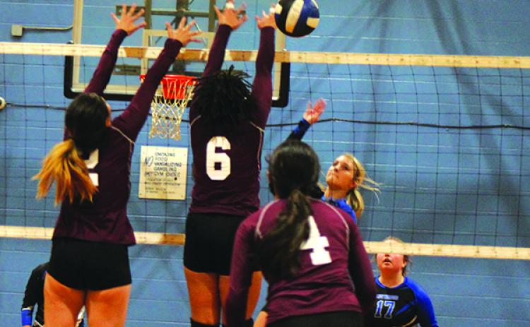 Peniel Baptist Academy’s Brook Williams (right) puts a kill down beyond Crescent City’s Veronica Ramirez (2) and Jordan Williams (6) during Thursday’s match at Jenkins Middle School. (MARK BLUMENTHAL / Palatka Daily News)