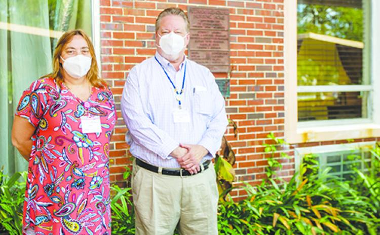 Windsor Care and Rehab Human Resources Director Kim Blackwelder and Administrator Bruce McCorkle smile beneath their masks Thursday outside the care facility formerly known as Crestwood Nursing Center.