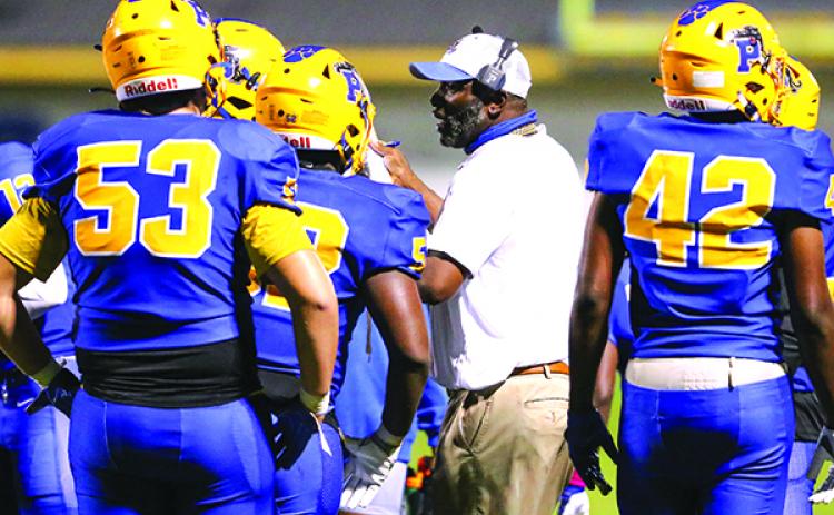 Palatka High School football coach Willie Fells talks and shows strategy with his players during their loss to Live Oak Suwannee on Oct. 9. (GREG OYSTER / Special To The Daily News)