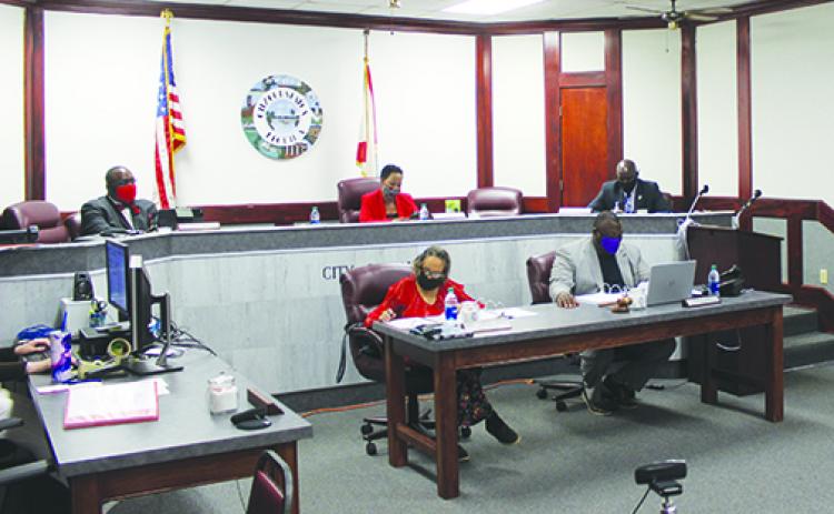 Palatka city commissioners are masked and spaced out during their meeting Thursday.