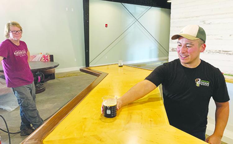 Azalea Brewing Co. head brewer Eli Miranda pours a beer in October when the Palatka brewery was almost completed. 