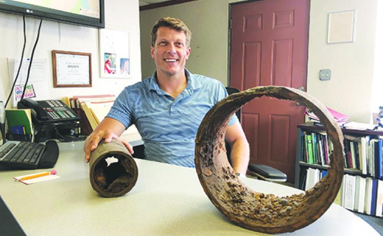 Palatka General Services Director Jonathan Griffith displays a piece of cast iron pipe that dates back to 1886 in his office.