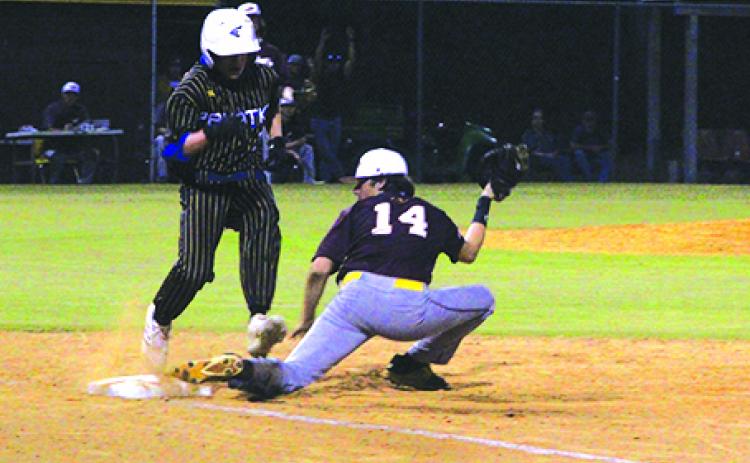 Palatka’s Hunter Keen is barely out at first base as Crescent City first baseman D.J. Hullett makes the play during the second inning of Monday’s Putnam County Tournament semifinal matchup. (ANTHONY RICHARDS / Palatka Daily News)