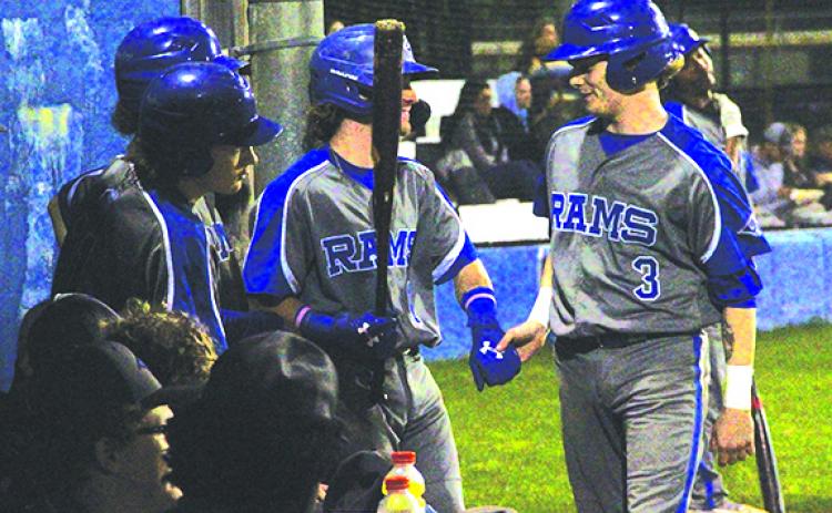 Interlachen’s Jason Dozier is congratulated by teammate Joey Bacco after scoring a second-inning run in the county tournament semifinal against Peniel Baptist Academy. (ANTHONY RICHARDS / Palatka Daily News)