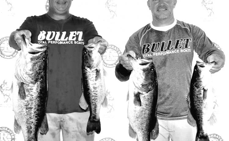 Lee Stalvey, left, and Jason Caldwell hold up their winning fish. (GREG WALKER / Special To The Daily News)