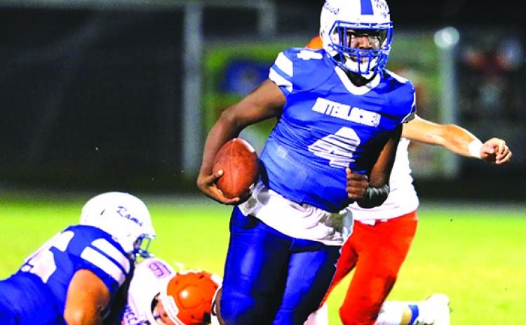 Interlachen High School football quarterback Reggie Allen Jr. scrambles for yards during a 2020 game. The Rams will remain in Region 1-3A next season. (GREG OYSTER / Special to the Daily News)