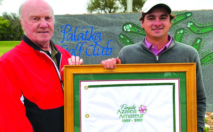 Palatka Mens Golf Association president David Cox, left, presents 2021 Florida Azalea Amateur winner Tyler Hitchner of Tuscaloosa, Alabama with a framed flag commemorating the event. Hitchner shot 4-under and defeated Michael Mattiace of Jacksonville in a playoff on Sunday. (DANNY HOOD / Special To The Daily News)