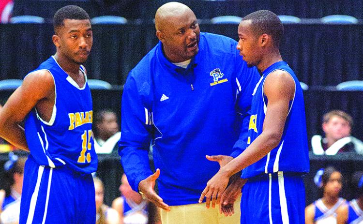 Donald Lockhart talks with players Da’Carr Smith (left) and Terence Evans as Palatka High’s coach during his team’s 68-49 loss to Plantation American Heritage in the FHSAA 5A semifinals at the RP Funding Center in Lakeland in 2013. (Daily News file photo)