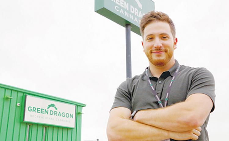 Alex Levine, chief development officer and co-owner of Green Dragon, stands in front of the company’s flagship cannabis dispensary in Denver.