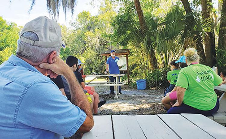 A Water Works Enviornmental Education Center volunteer teaches students about gopher tortoises Thursday.