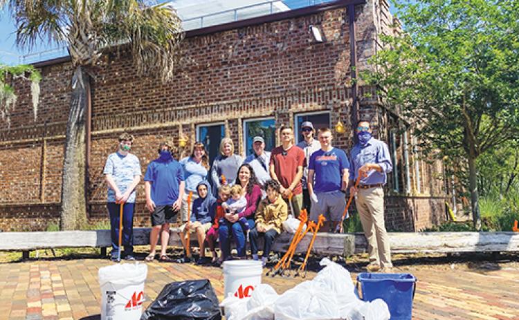 A group of Putnam County residents takes a break after spending Thursday morning cleaning up the Palatka riverfront in observation of Earth Day.