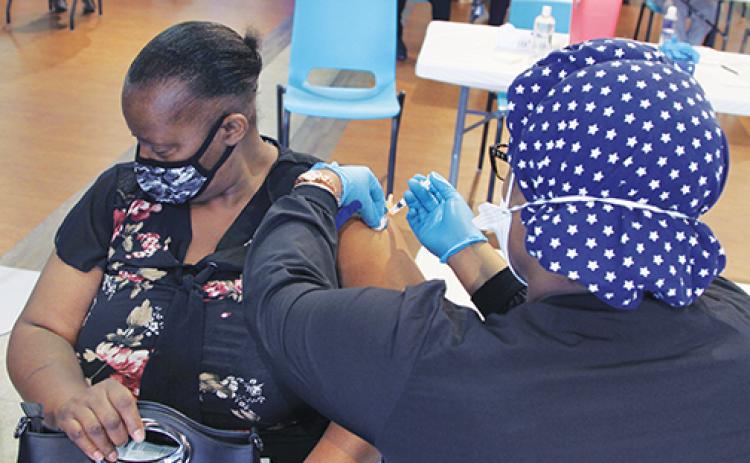 Health officials vaccinate a Putnam resident during March’s vaccine event at St. Johns River State College in Palatka, which partnered with Mt. Tabor First Baptist Church to host the event. 