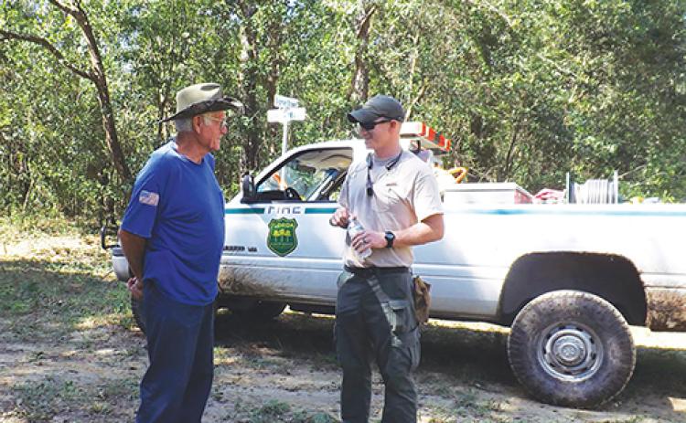 A Florida Forest Service ranger talks about forestry with a Putnam County resident.