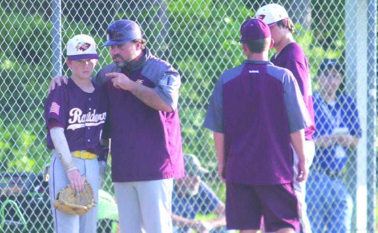 Crescent City High baseball coach Tim Ross, at left, gives encouragement to Raiders second baseman Camron Boyle during last week’s District 8-1A victory against Wildwood. (MARK BLUMENTHAL / Palatka Daily News)