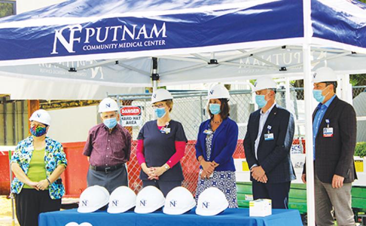 Putnam Community Medical Center board members gather last week to celebrate breaking ground on the site of the hospital’s upcoming MRI unit.