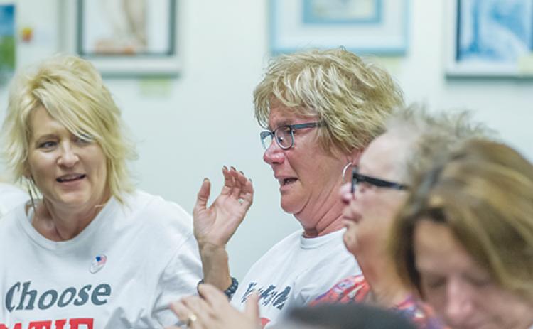 Kathleen “Katie” Berg, center, reacts to winning a seat on the Crescent City Commission during a special election April 30, 2019.