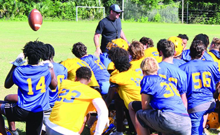 New Palatka High School football coach Patrick Turner talks with his players at the end of Monday’s final practice before tonight’s game. (MARK BLUMENTHAL / Palatka Daily News)