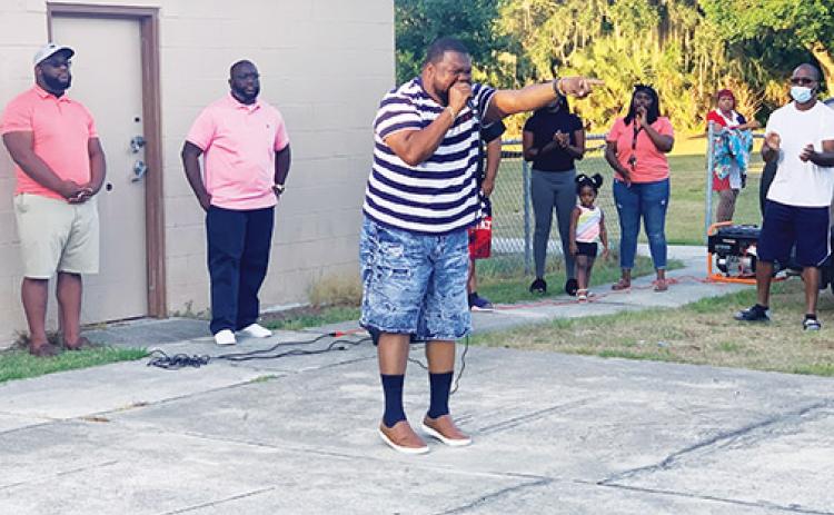 Emerge Church of Palatka Pastor Leo Parker gives a sermon calling for unity during a vigil at Booker Park on Tuesday after two Palatka shootings since Sunday.