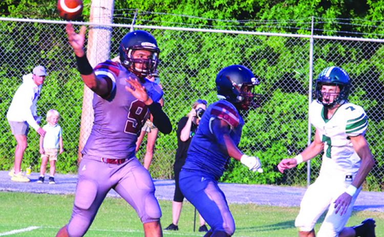Crescent City High School starting quarterback Robert Johnson throws a first-half pass while Father Lopez defender Cayden Allen (7) hones in on him. (ANTHONY RICHARDS / Palatka Daily News)