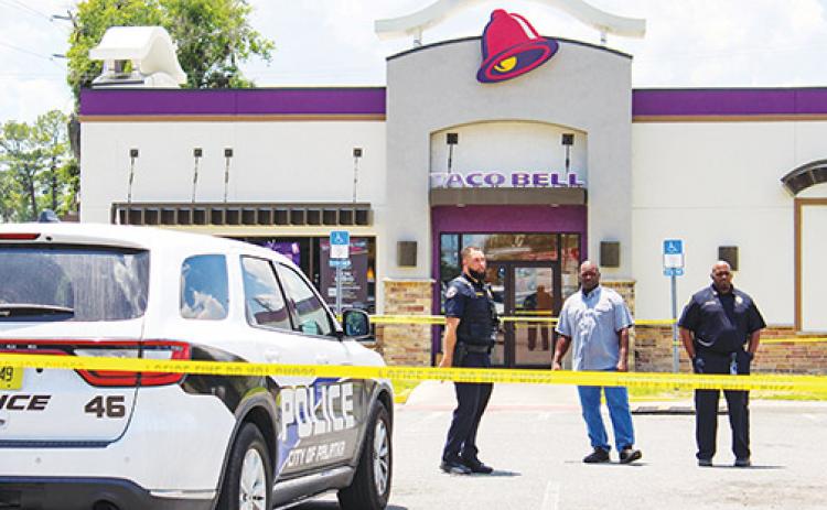 Palatka Police Department Chief Jason Shaw, right, and members of the department stand outside Taco Bell in Palatka, the scene of a stabbing Thursday afternoon.