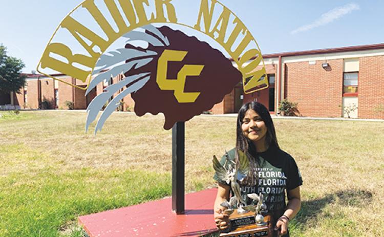 Crescent City High School senior Lizbeth Espinoza, the Putnam County School District’s top scholar for the 2020-2021 school year, holds the Robert W. Webb Award of Excellence she was awarded earlier this month.