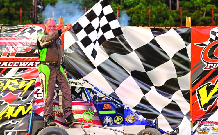 John Crowder stands with the checkered flag in victory lane after winning the non-wing mini sprints class at Church in the Dirt at The Clip at Putnam Raceway on Sunday. (Submitted / The Clip at Putnam Raceway)