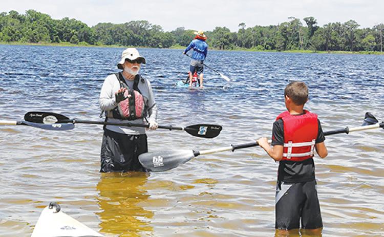Sam Carr, vice chairman of Putnam Blueways and Trails Citizen Service Organization, teaches a child to kayak during Cops, Kids and Kayaks in June 2018.