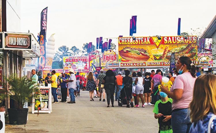 Fair attendees walk around the Putnam County Fairgrounds, which has been allocated $1.2 million from the state Legislature.